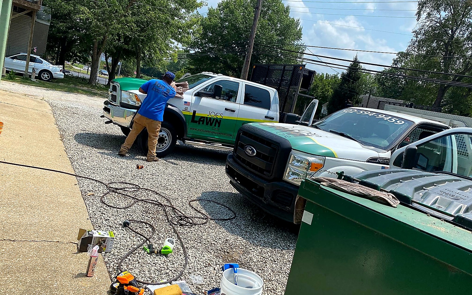 Joe's Lawn Care branded trucks and crew equipment